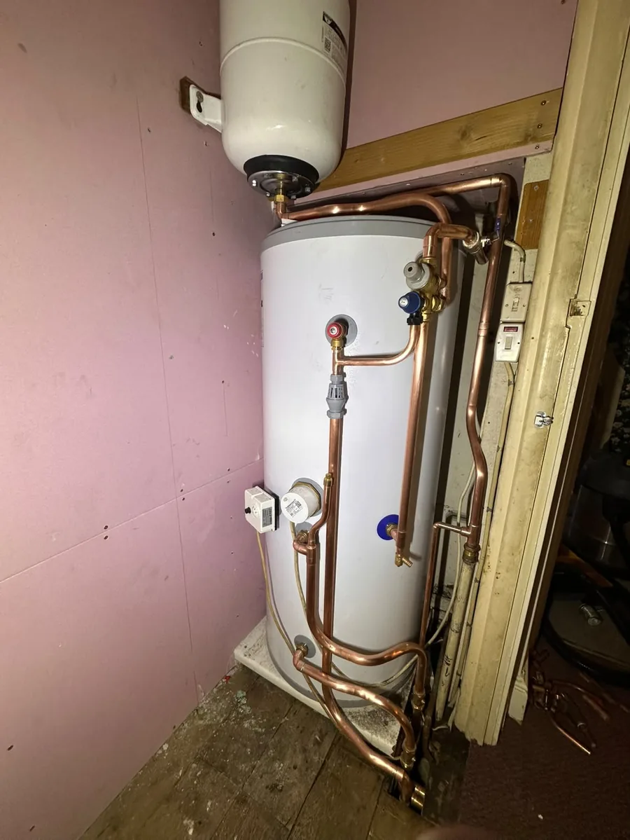 New unvented hot water cylinder with expansion vessel and copper pipework in the same cupboard