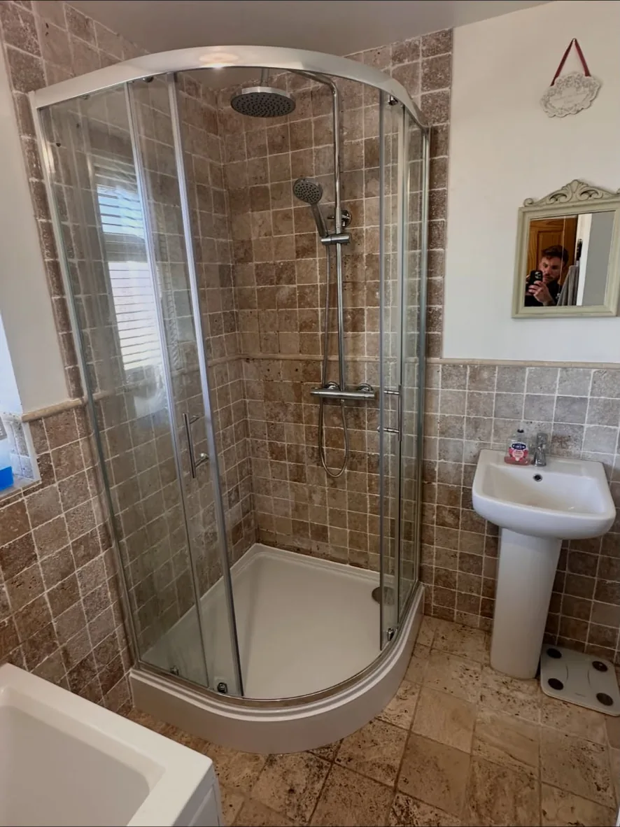 New quadrant shower enclosure with a fitted shower and tray after the work